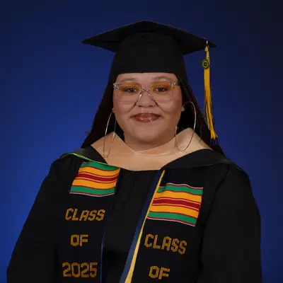 Photo of Brianna Davis in their graduation gown and cap.