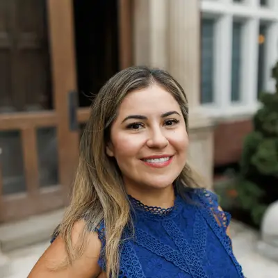 A photo of Tania Bermejo standing outside in front of a building.
