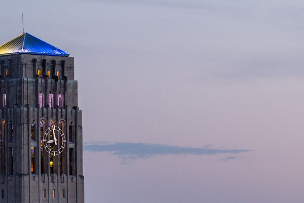 Photo of Burton Tower illuminated with U-M colors.