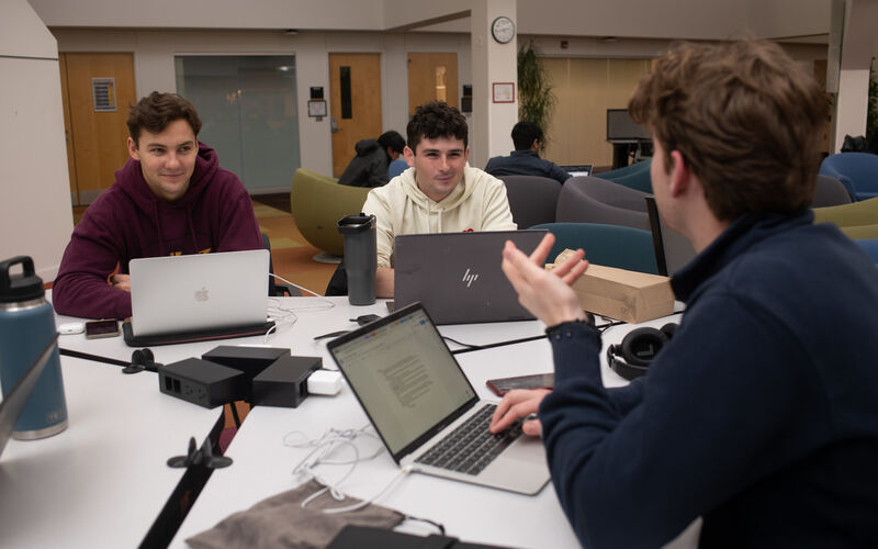 3 people talking at a table
