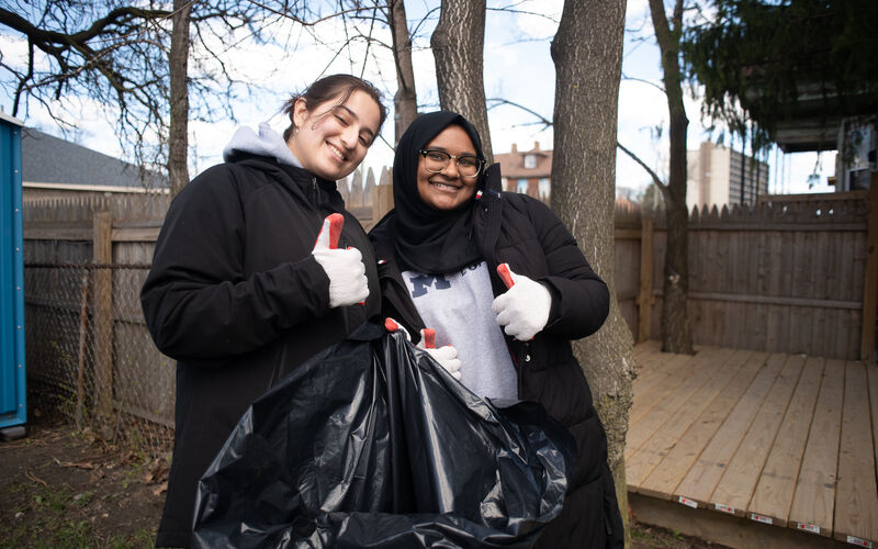 Two people picking up garbage