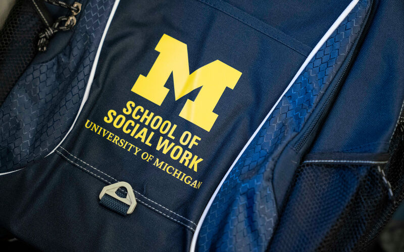 A backpack with the Michigan School of Social Work logo