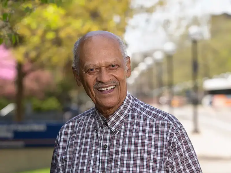 Dr. Curtis standing outside the School of Social Work building.