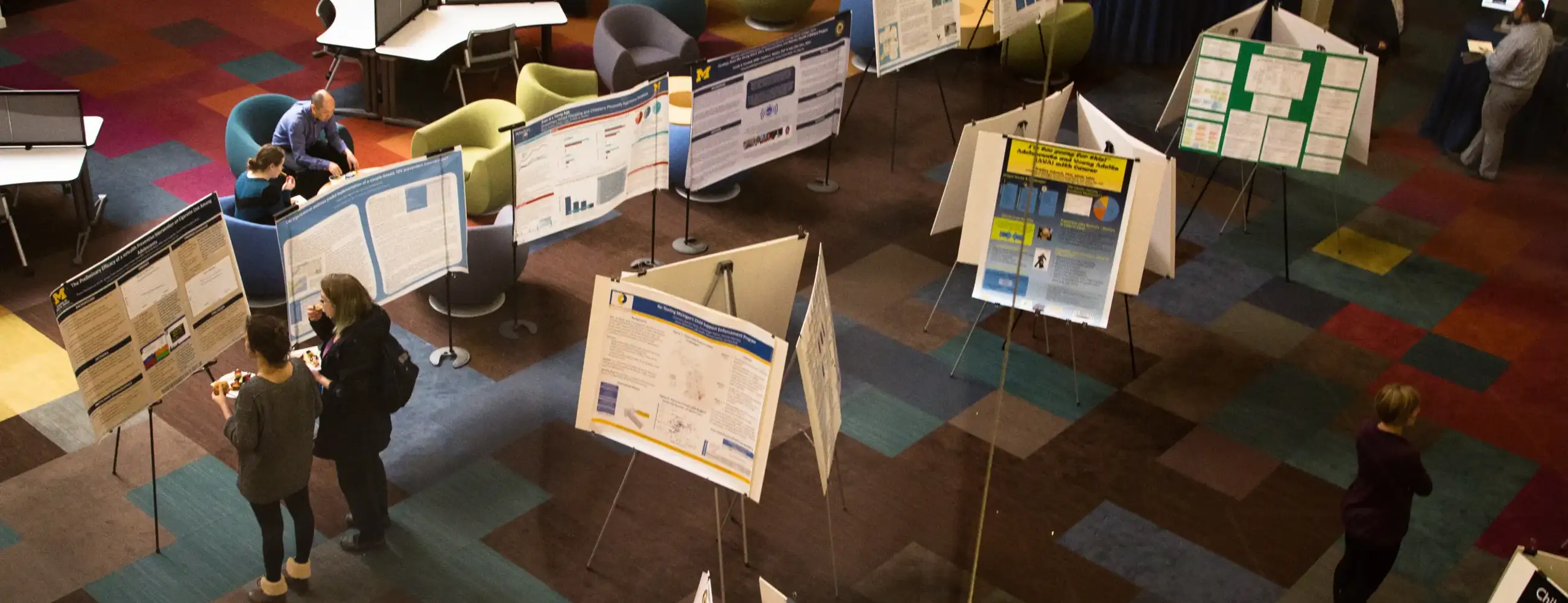 People in the SSW Atrium looking at research posters.