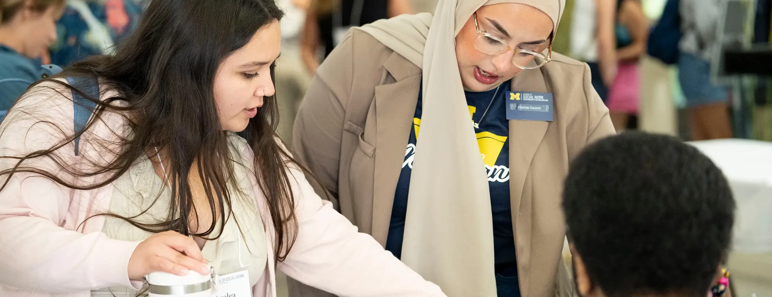 A work study helping another student during orientation.