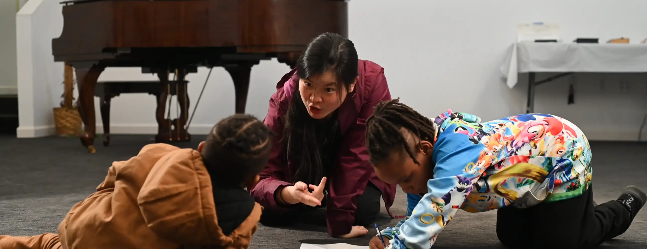 person playing with children on the floor