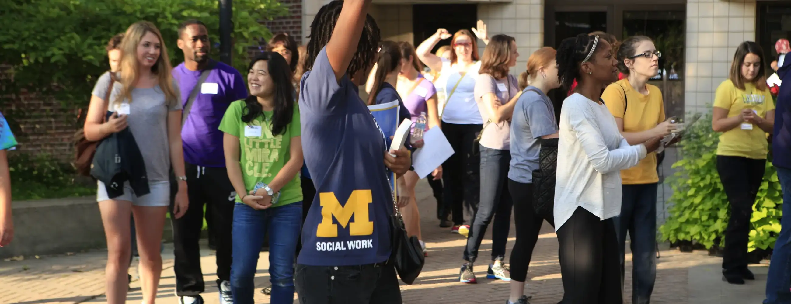 Incoming students gather outside the School of Social Work during Seed Week orientation.