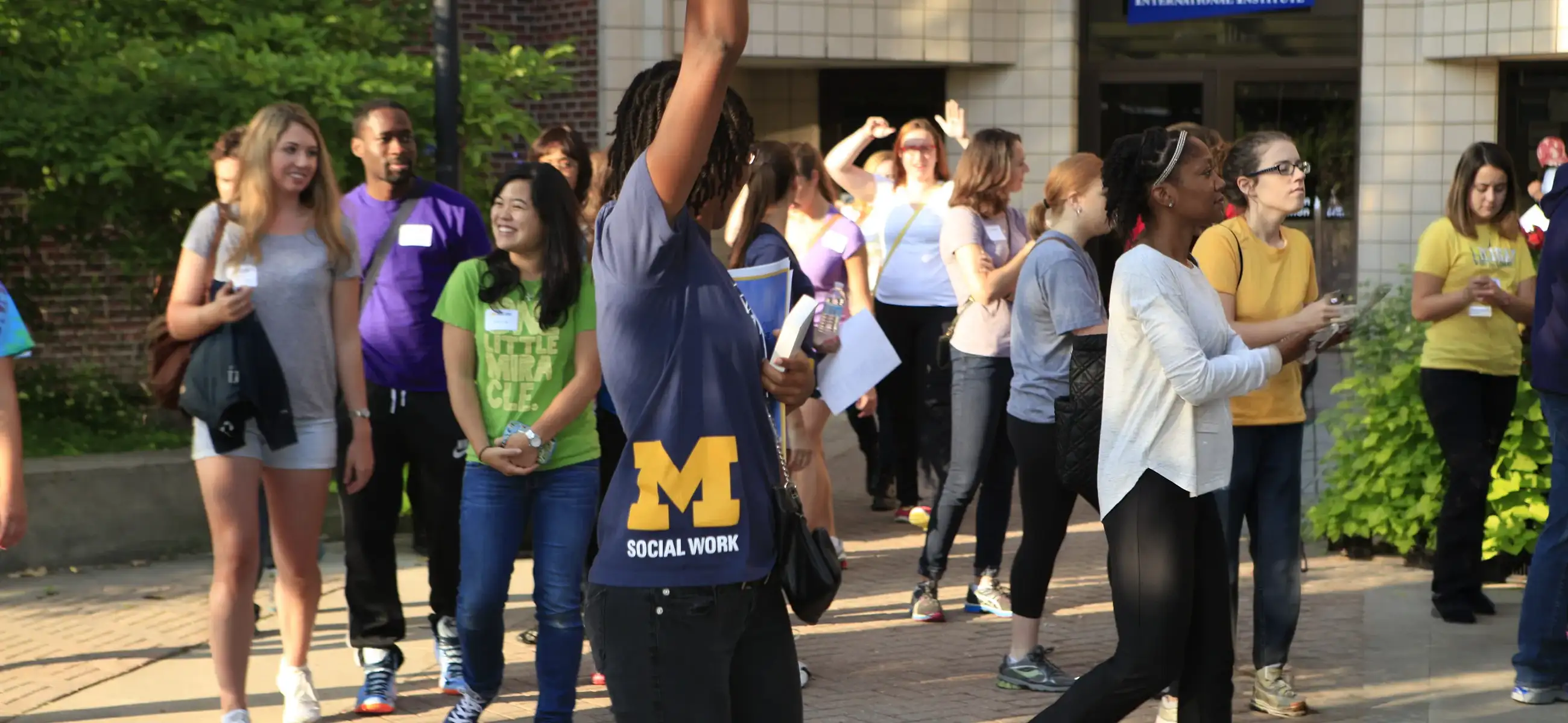 Incoming students gather outside the School of Social Work during Seed Week orientation.