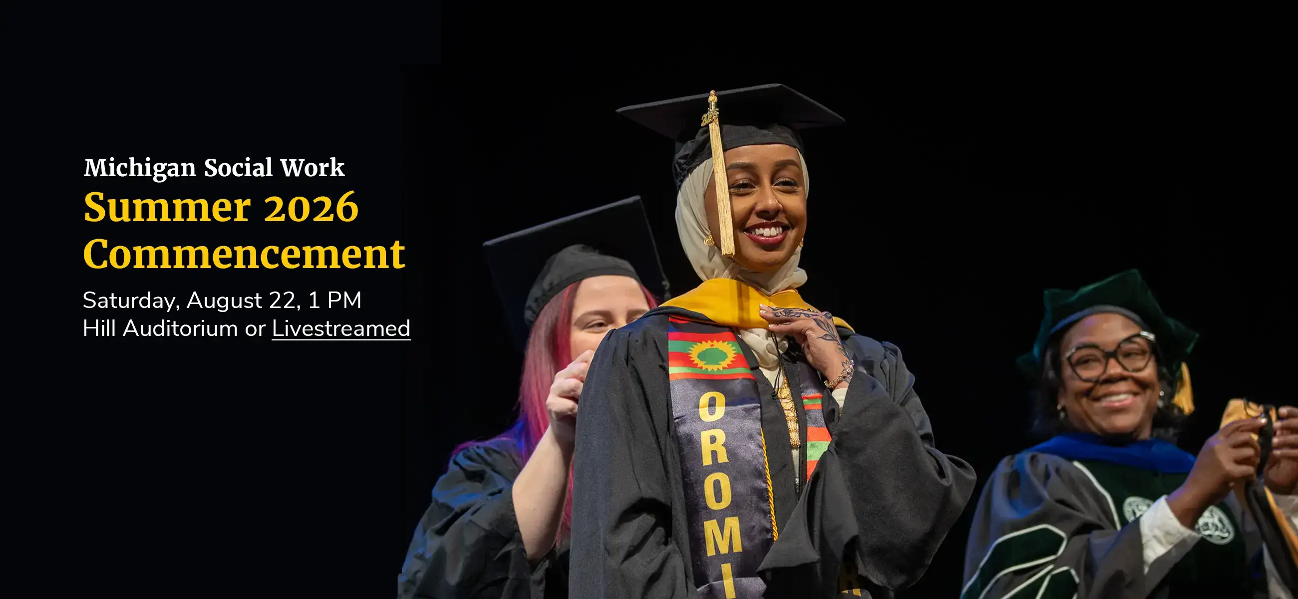 Michigan Social Work Summer 2026 Commencement. Saturday, August 22, 1 PM, Hill Auditorium or livestreamed. A graduate smiles as she is hooded on stage, wearing an Oromia stole.