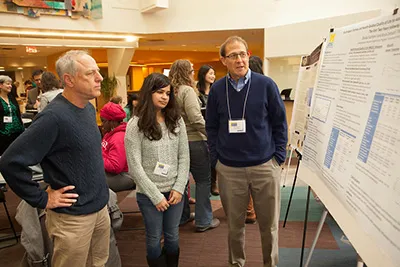 People looking at a research poster