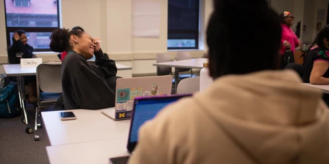 Two people laughing at a table