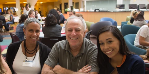 Three people smiling at the camera